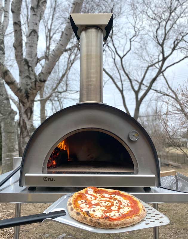 cooked pizza with Cru Champion Bundle wood fired oven
